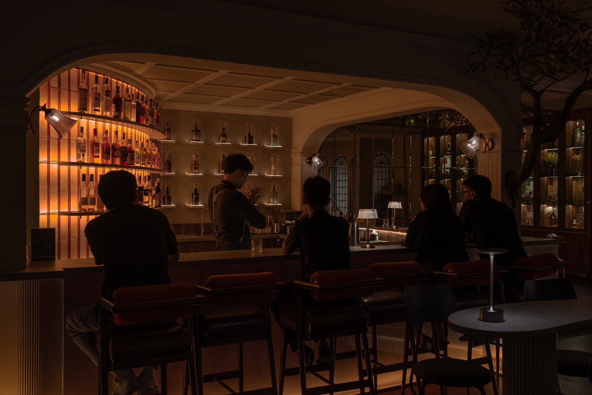 Warm lighting, curved arches and the bar at Sevensens.
