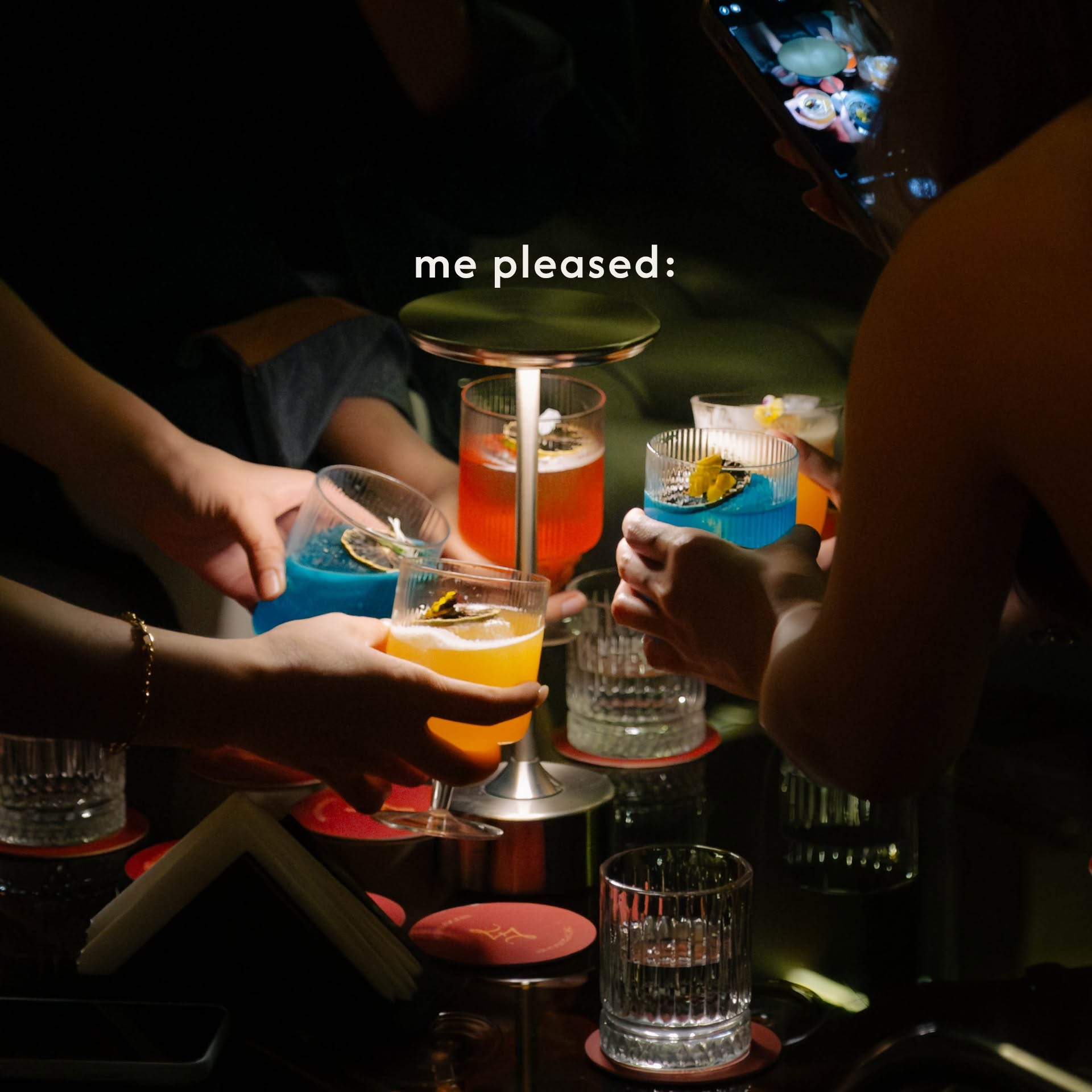 Cocktails raised around a table at Sevensens.